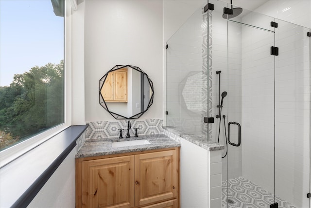 bathroom with vanity and a shower with shower door