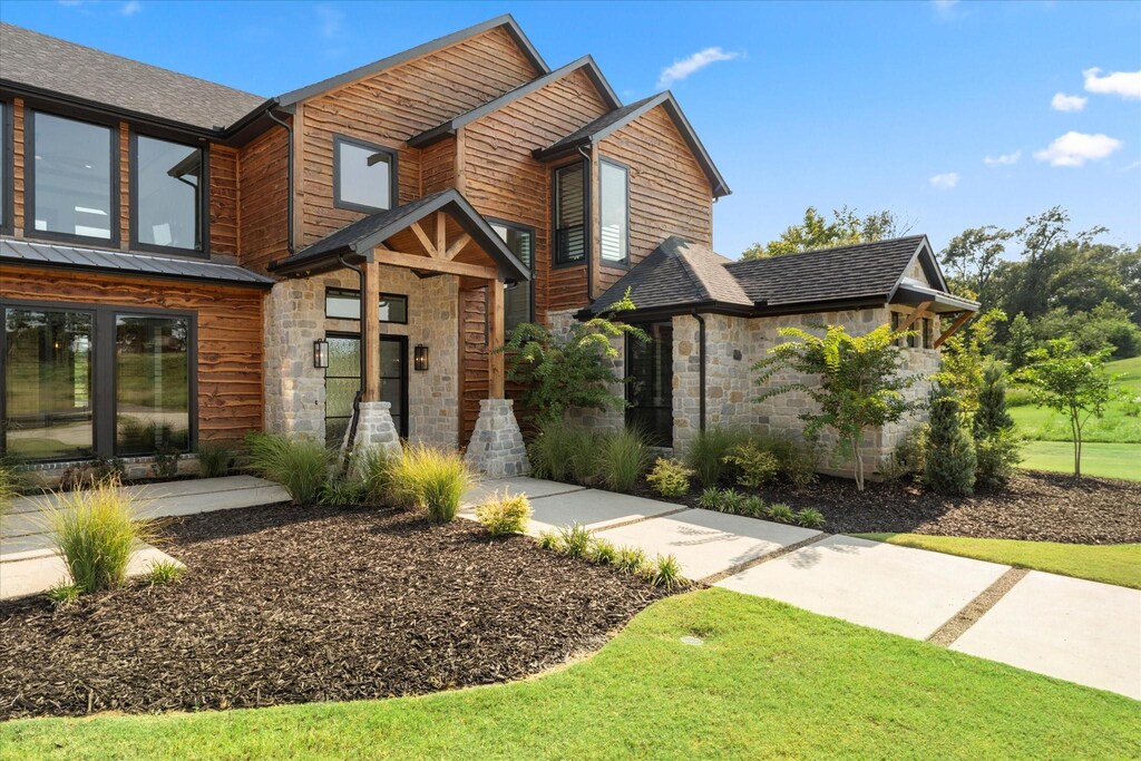 view of front of home featuring a garage and a front lawn