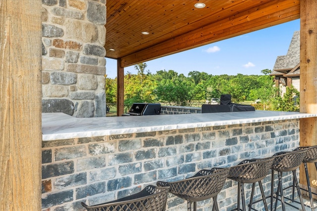 view of patio featuring area for grilling and exterior bar