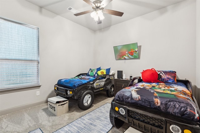 bedroom with ceiling fan and carpet floors