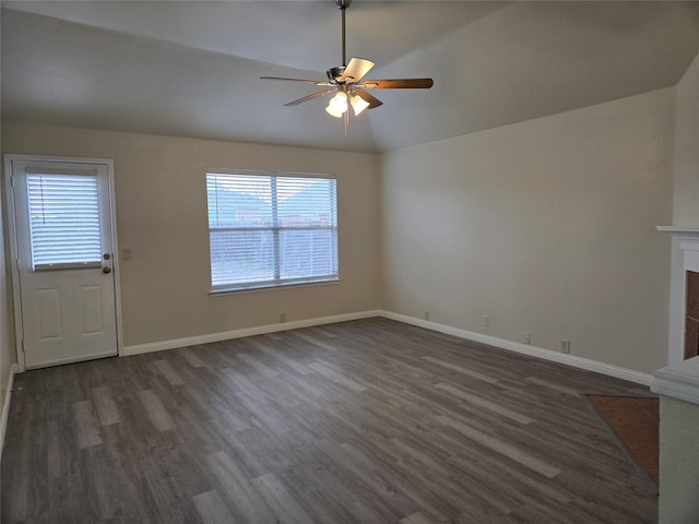 unfurnished living room featuring dark wood-type flooring, ceiling fan, vaulted ceiling, and a wealth of natural light