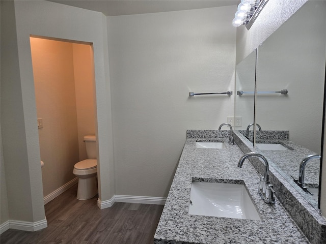 bathroom featuring hardwood / wood-style flooring, vanity, and toilet