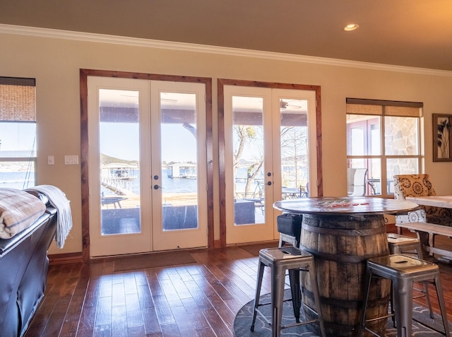 doorway to outside with french doors, crown molding, and dark hardwood / wood-style flooring