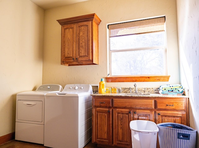 washroom featuring cabinets, separate washer and dryer, and sink