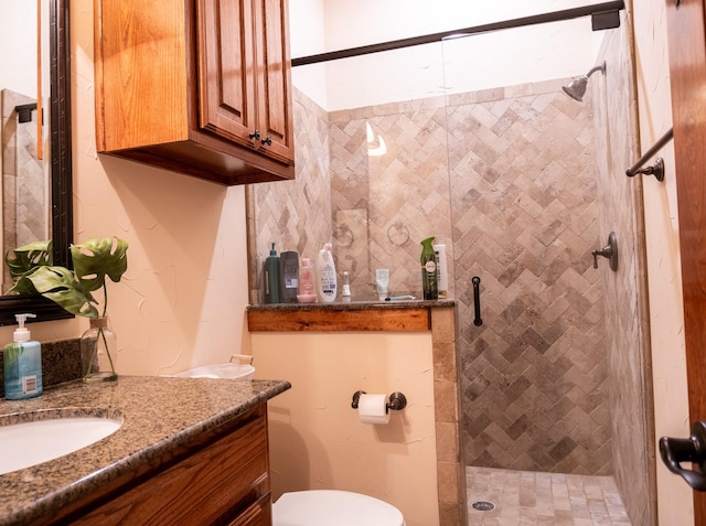 bathroom with vanity, a shower with shower door, and toilet