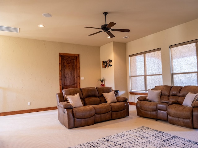 carpeted living room featuring ceiling fan