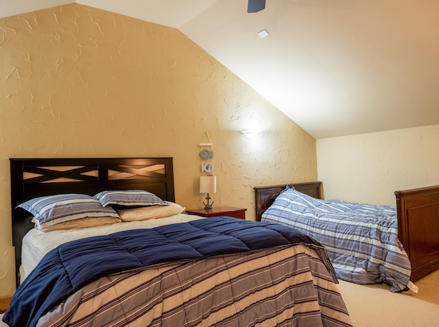 bedroom featuring lofted ceiling and carpet