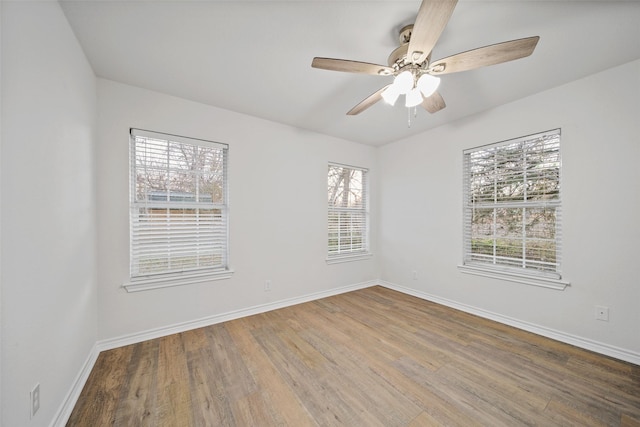 spare room with ceiling fan and wood-type flooring