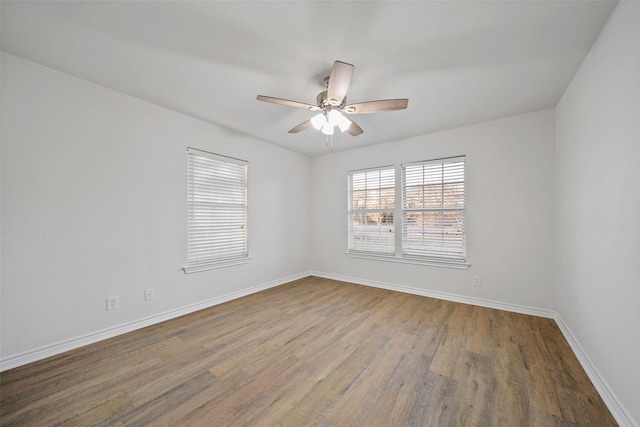 empty room featuring ceiling fan and hardwood / wood-style floors