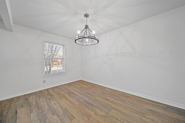 unfurnished dining area with hardwood / wood-style floors and a notable chandelier