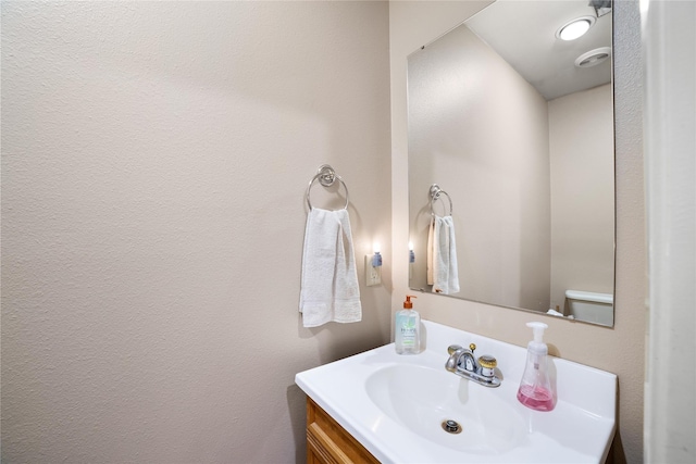 bathroom featuring vanity and toilet