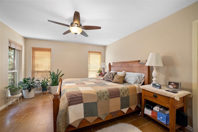 tiled bedroom featuring ceiling fan