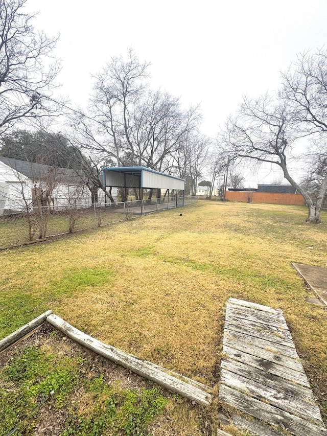 3033 Anita Dr, Garland, TX 75041 - view of yard featuring fence, an outbuilding, and a detached carport