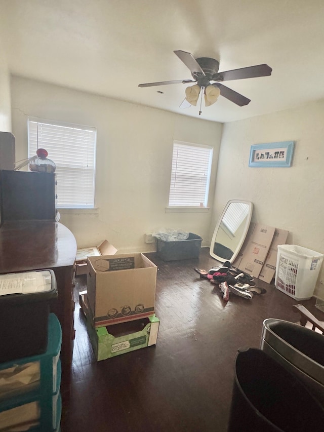 interior space with dark wood-type flooring and ceiling fan