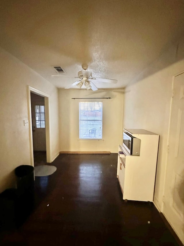 unfurnished room featuring dark hardwood / wood-style floors and ceiling fan