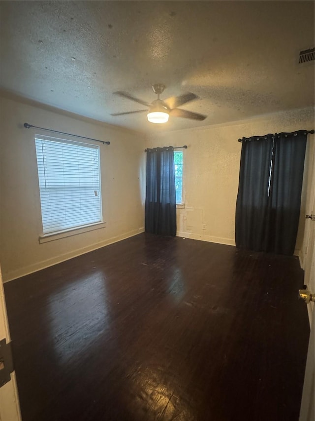 3033 Anita Dr, Garland, TX 75041 - empty room with baseboards, a ceiling fan, a textured ceiling, and wood finished floors