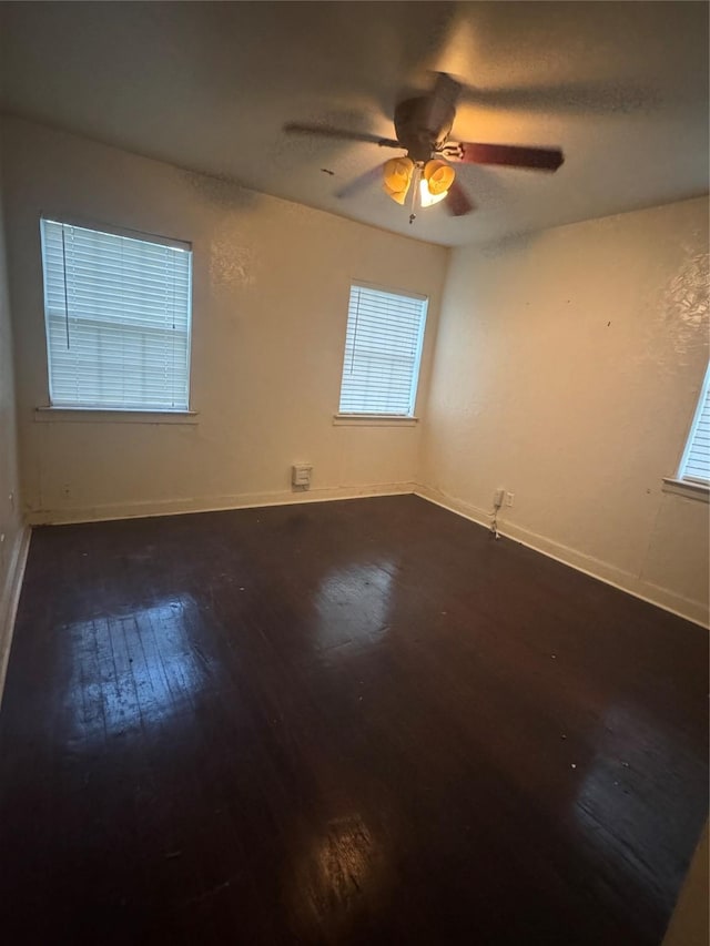 3033 Anita Dr, Garland, TX 75041 - spare room with a ceiling fan, baseboards, and dark wood-style floors