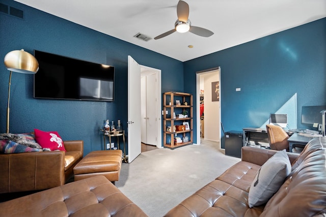 carpeted living room with ceiling fan