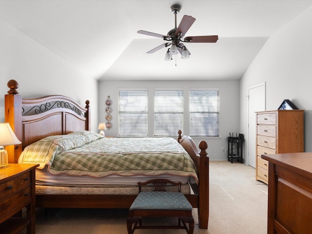 carpeted bedroom featuring lofted ceiling, multiple windows, and ceiling fan