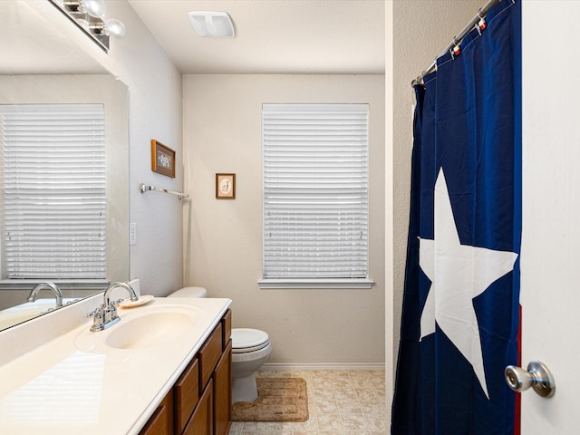 bathroom featuring vanity and toilet