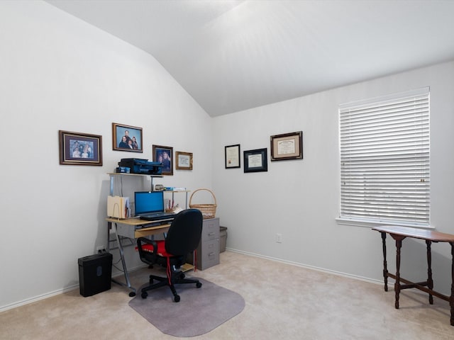 office space with vaulted ceiling and light colored carpet