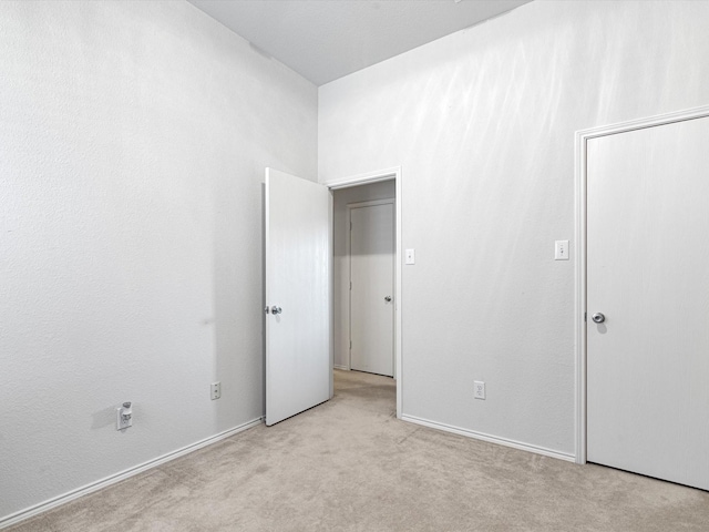 unfurnished bedroom featuring light colored carpet