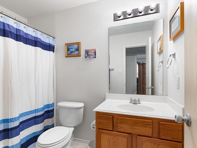 bathroom featuring vanity, toilet, and walk in shower