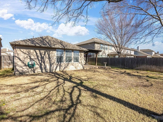 back of house with a lawn