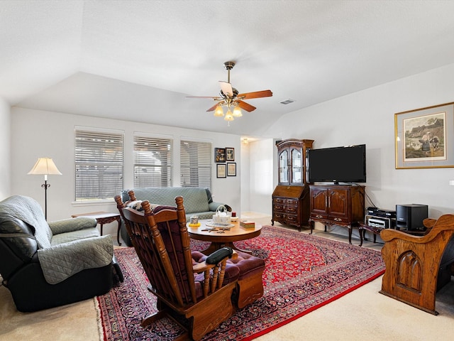 living room with vaulted ceiling, carpet, and ceiling fan