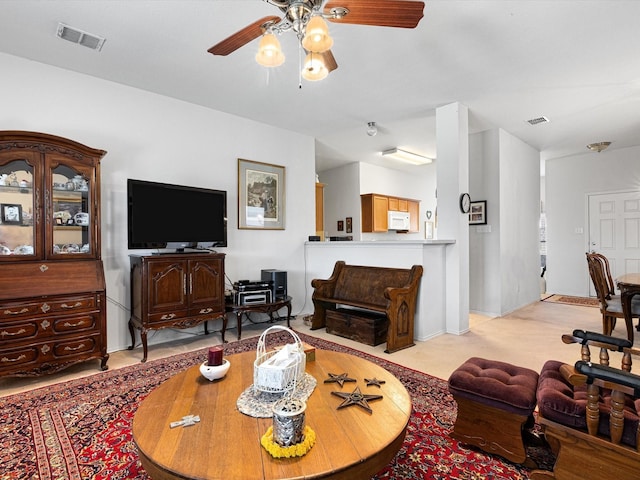 carpeted living room with ceiling fan