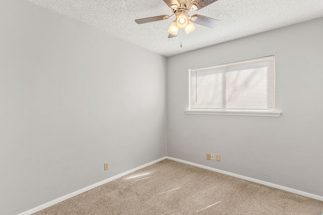 carpeted empty room featuring ceiling fan and a textured ceiling