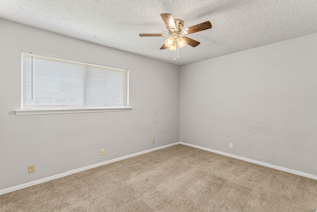 spare room with ceiling fan, carpet floors, and a textured ceiling