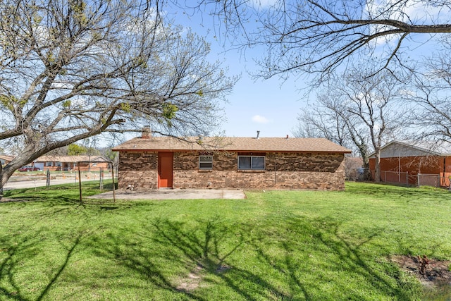 rear view of house with a yard and a patio