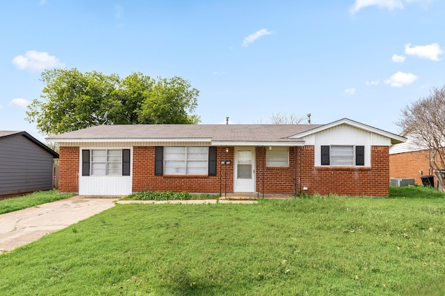 ranch-style house featuring central AC and a front yard