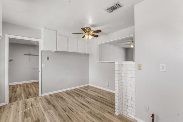 spare room featuring light hardwood / wood-style flooring and ceiling fan