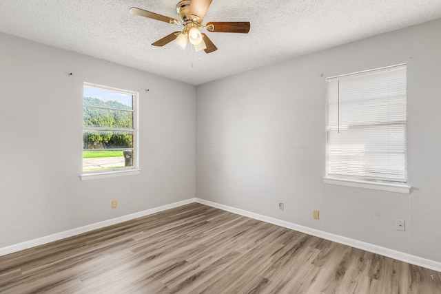 unfurnished room featuring ceiling fan, a textured ceiling, and light hardwood / wood-style floors