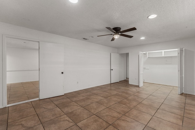 2920 Cunningham Dr, Wichita Falls, TX 76308 - unfurnished bedroom with ceiling fan, tile patterned floors, and a textured ceiling
