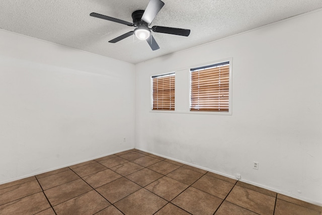 2920 Cunningham Dr, Wichita Falls, TX 76308 - empty room featuring dark tile patterned floors, ceiling fan, and a textured ceiling