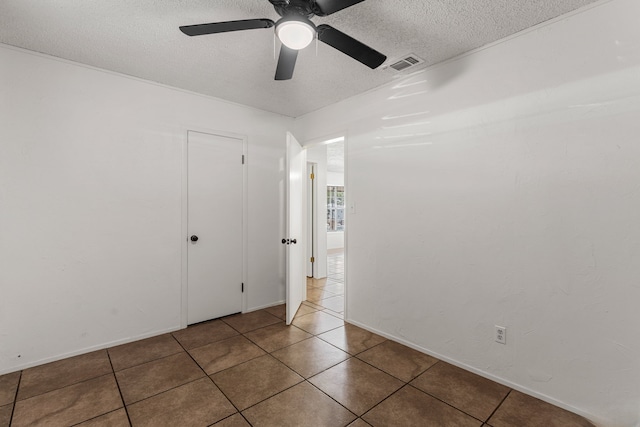 2920 Cunningham Dr, Wichita Falls, TX 76308 - tiled spare room with ceiling fan and a textured ceiling