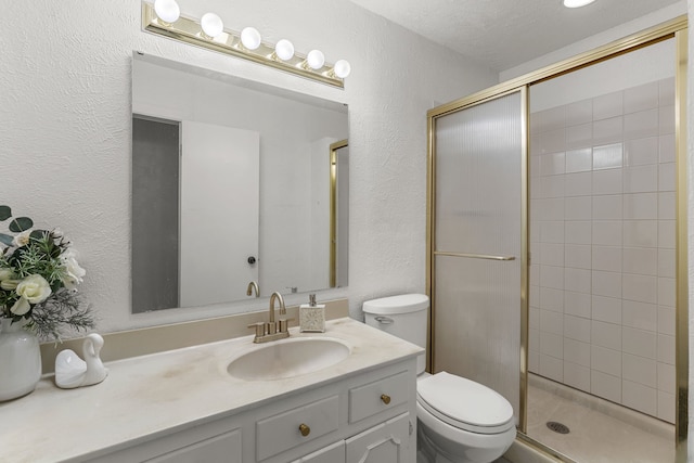 2920 Cunningham Dr, Wichita Falls, TX 76308 - bathroom with vanity, toilet, a textured ceiling, and a shower with shower door