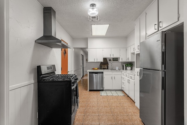 2920 Cunningham Dr, Wichita Falls, TX 76308 - kitchen featuring tasteful backsplash, white cabinetry, stainless steel appliances, a textured ceiling, and wall chimney exhaust hood