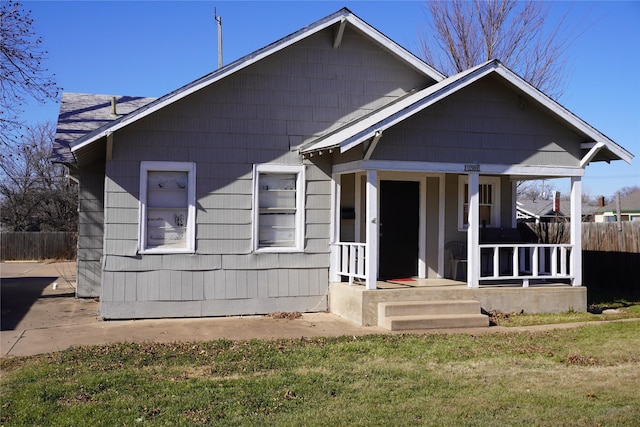 bungalow with a front yard and covered porch