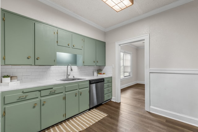 kitchen with tasteful backsplash, stainless steel dishwasher, green cabinets, and sink