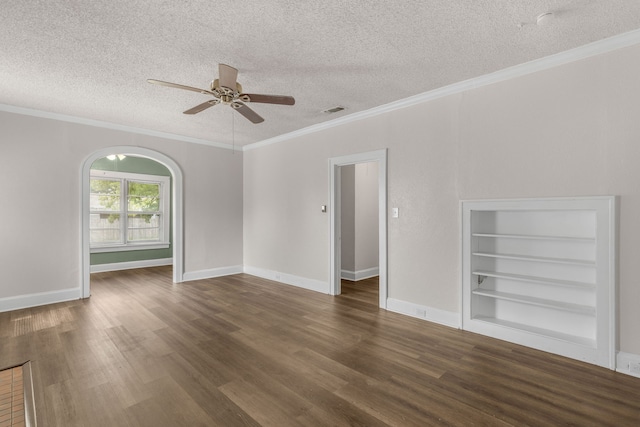 unfurnished room featuring crown molding, dark hardwood / wood-style floors, a textured ceiling, and built in shelves