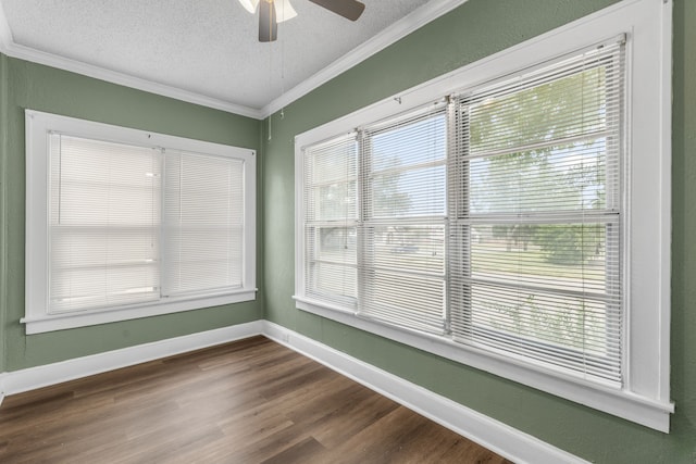 empty room featuring crown molding, ceiling fan, a healthy amount of sunlight, and a textured ceiling