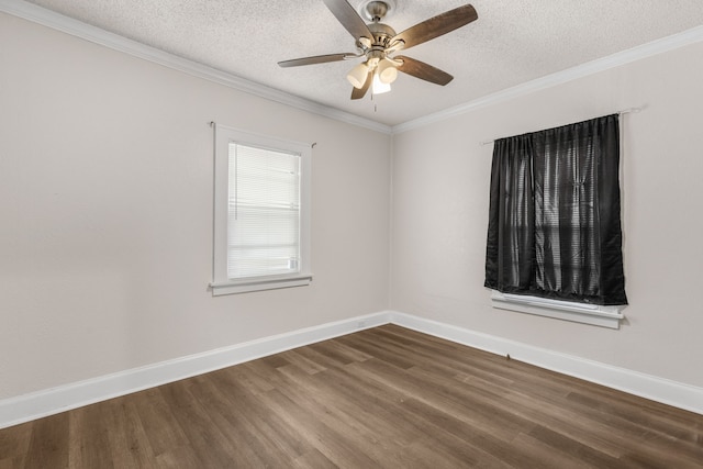 spare room featuring dark wood-type flooring, ornamental molding, and a textured ceiling