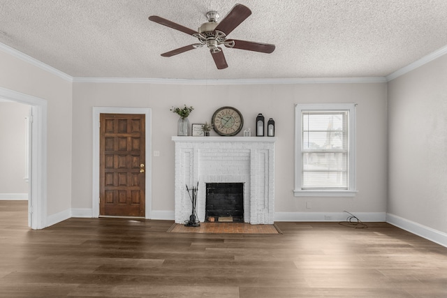 unfurnished living room with crown molding, a brick fireplace, and a textured ceiling