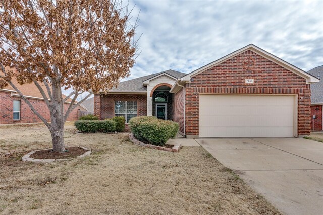 single story home with a garage and a front yard