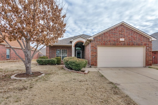 view of front of home with a garage and a front lawn