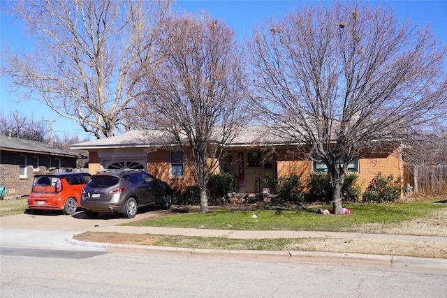 ranch-style home with a garage and a front yard